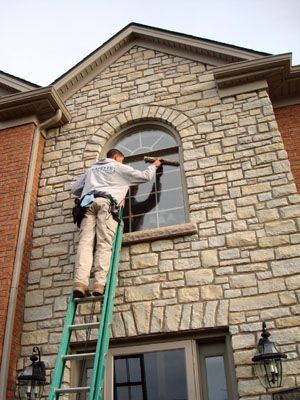 Diamond Window Cleaning technician at work on an Omaha home